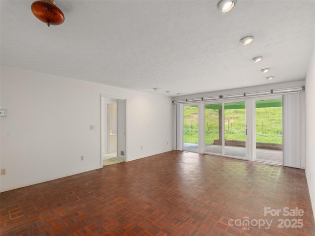 202 Terrell Rd, Clyde, NC 28721 - spare room featuring a textured ceiling