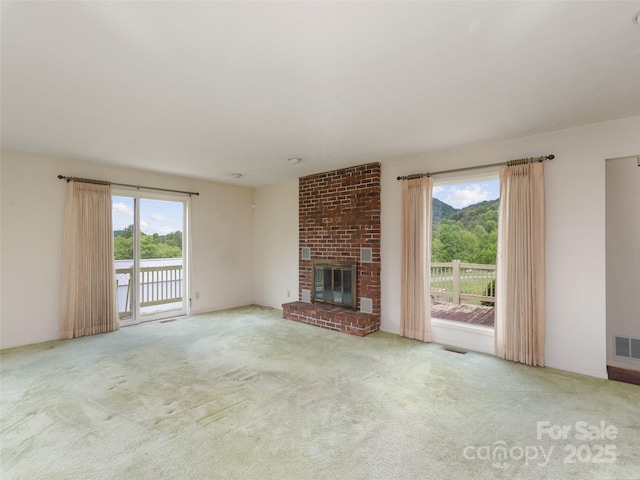 202 Terrell Rd, Clyde, NC 28721 - unfurnished living room with carpet floors and a brick fireplace
