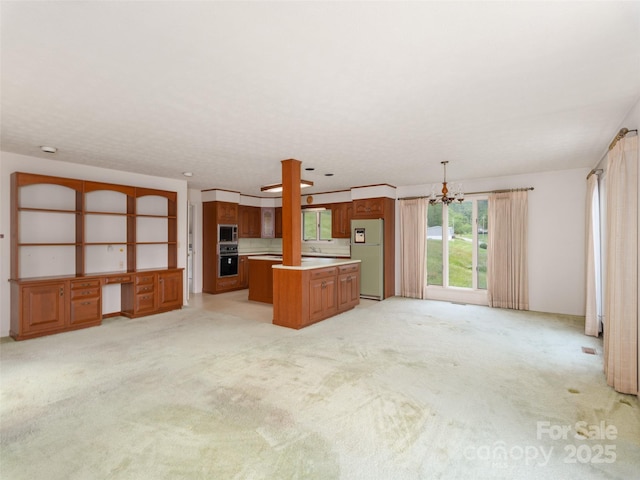 202 Terrell Rd, Clyde, NC 28721 - unfurnished living room with light carpet, a chandelier, and a desk