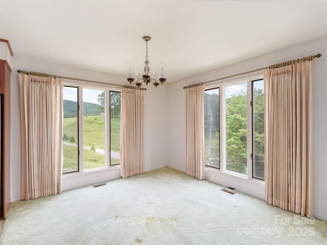 202 Terrell Rd, Clyde, NC 28721 - empty room featuring a chandelier, healthy amount of natural light, and carpet