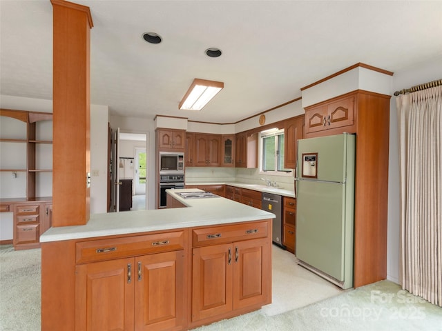 202 Terrell Rd, Clyde, NC 28721 - kitchen with appliances with stainless steel finishes, a peninsula, light countertops, light colored carpet, and brown cabinets