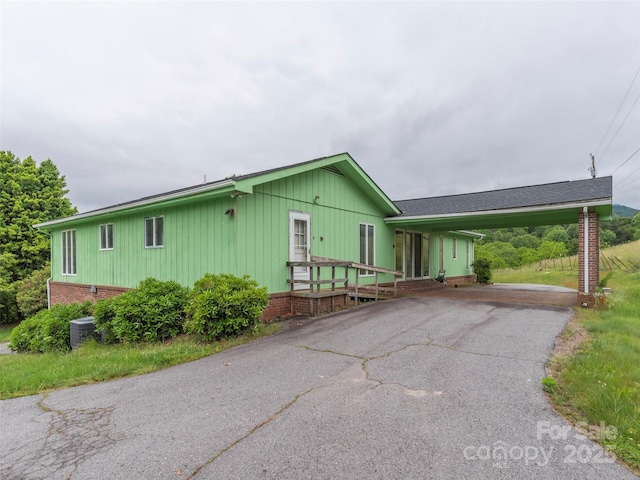 202 Terrell Rd, Clyde, NC 28721 - view of front facade with driveway, an attached carport, and board and batten siding