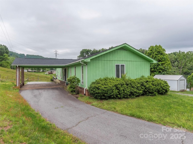 202 Terrell Rd, Clyde, NC 28721 - ranch-style home featuring a front yard, driveway, and an attached carport