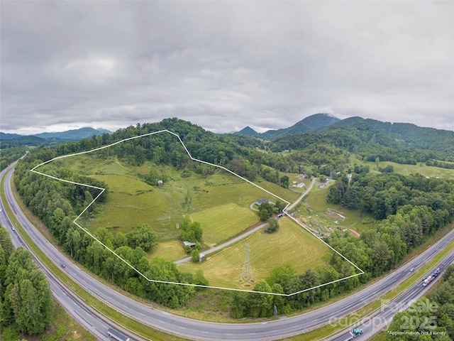 202 Terrell Rd, Clyde, NC 28721 - aerial view of property and surrounding area featuring property parcel outlined, a highway, and a mountain backdrop