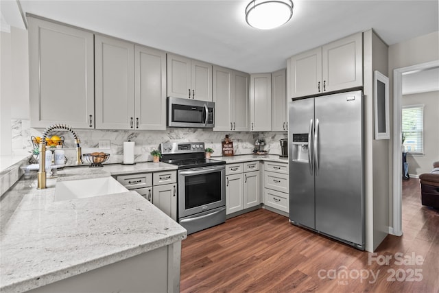 2146 Marwood Ln, Albemarle, NC 28001 - kitchen with appliances with stainless steel finishes, a sink, dark wood-style floors, light stone countertops, and backsplash