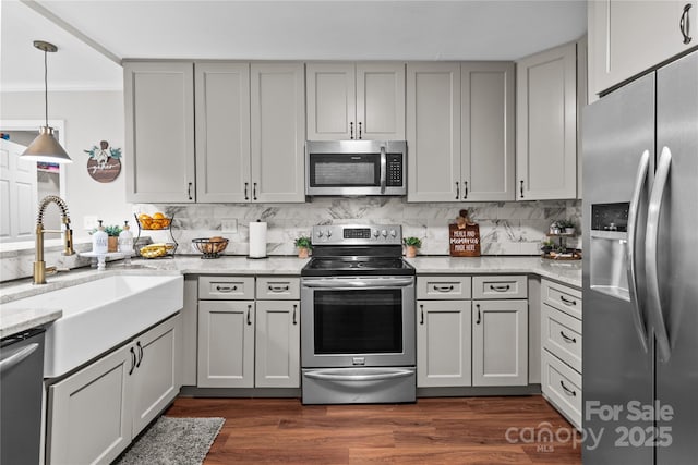 2146 Marwood Ln, Albemarle, NC 28001 - kitchen with appliances with stainless steel finishes, a sink, decorative backsplash, light stone countertops, and decorative light fixtures