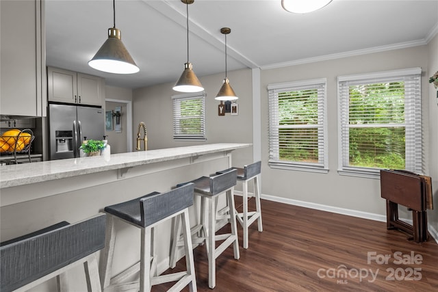 2146 Marwood Ln, Albemarle, NC 28001 - kitchen featuring stainless steel fridge, a breakfast bar, light stone countertops, healthy amount of natural light, and crown molding