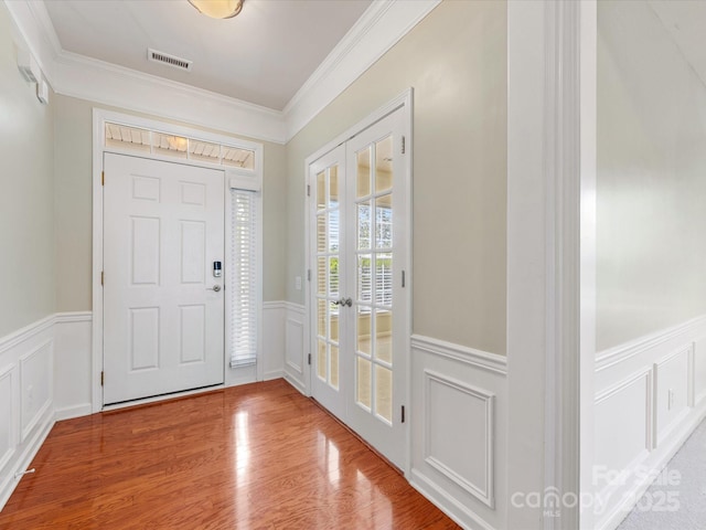 8603 Robinson Meadow Ct, Charlotte, NC 28277 - entrance foyer with a wainscoted wall, crown molding, french doors, a decorative wall, and wood finished floors