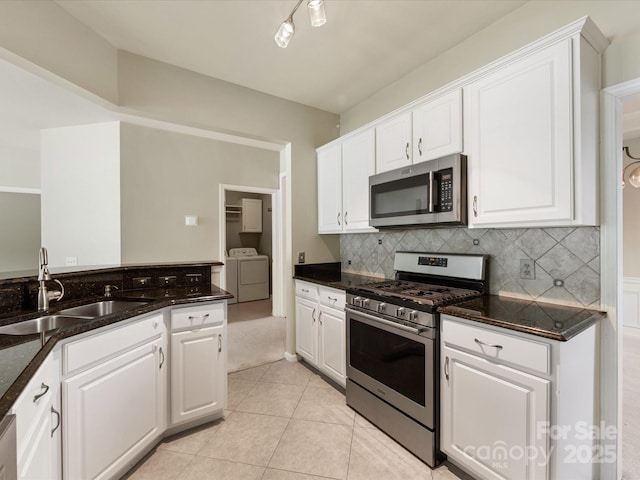 8603 Robinson Meadow Ct, Charlotte, NC 28277 - kitchen with stainless steel appliances, washer and dryer, white cabinetry, and backsplash