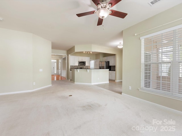 8603 Robinson Meadow Ct, Charlotte, NC 28277 - unfurnished living room featuring light carpet, ceiling fan, and healthy amount of natural light