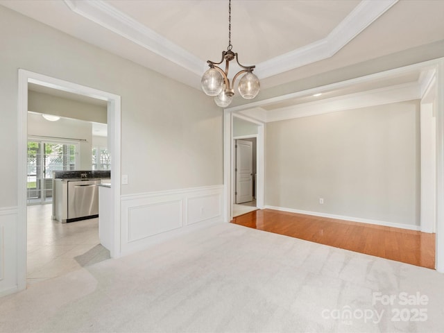 8603 Robinson Meadow Ct, Charlotte, NC 28277 - empty room featuring a chandelier, ornamental molding, light carpet, wainscoting, and a decorative wall