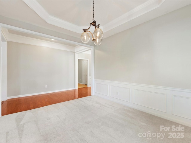 8603 Robinson Meadow Ct, Charlotte, NC 28277 - carpeted empty room with a chandelier, ornamental molding, wainscoting, a raised ceiling, and a decorative wall