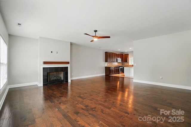 6618 Alexander Rd, Charlotte, NC 28270 - unfurnished living room with ceiling fan, a tile fireplace, dark wood-style flooring, baseboards, and recessed lighting