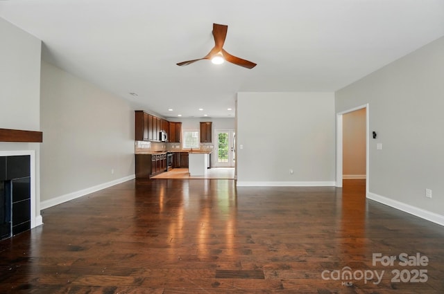 6618 Alexander Rd, Charlotte, NC 28270 - unfurnished living room featuring a ceiling fan, baseboards, wood finished floors, recessed lighting, and a tiled fireplace