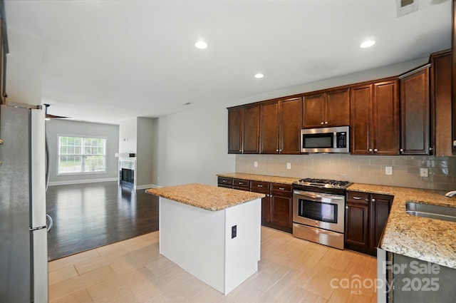 6618 Alexander Rd, Charlotte, NC 28270 - kitchen featuring stainless steel appliances, a center island, decorative backsplash, a sink, and recessed lighting