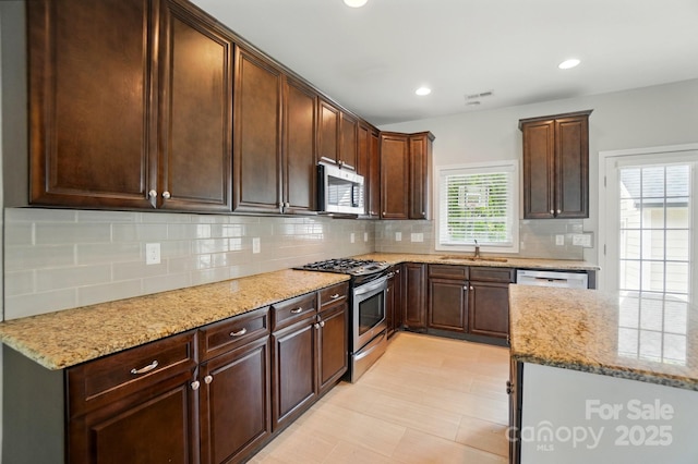 6618 Alexander Rd, Charlotte, NC 28270 - kitchen with appliances with stainless steel finishes, a sink, decorative backsplash, light stone counters, and recessed lighting