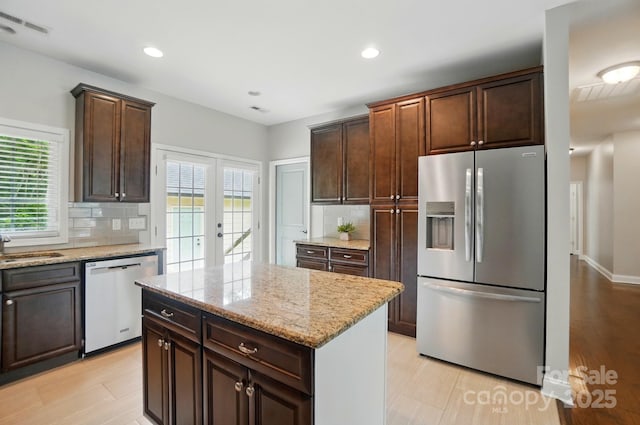 6618 Alexander Rd, Charlotte, NC 28270 - kitchen with stainless steel fridge, dishwasher, backsplash, french doors, and light stone counters