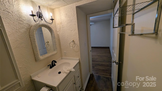 105 Toxaway Views Dr Unit 402, Lake Toxaway, NC 28747 - bathroom featuring a textured wall, wood finished floors, vanity, and baseboards