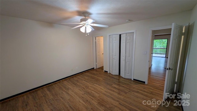 105 Toxaway Views Dr Unit 402, Lake Toxaway, NC 28747 - unfurnished bedroom featuring wood finished floors, baseboards, a closet, and ceiling fan