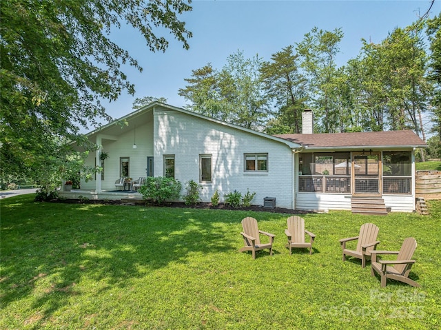 5 Lowry Ln, Weaverville, NC 28787 - rear view of house with a sunroom, a chimney, and a yard