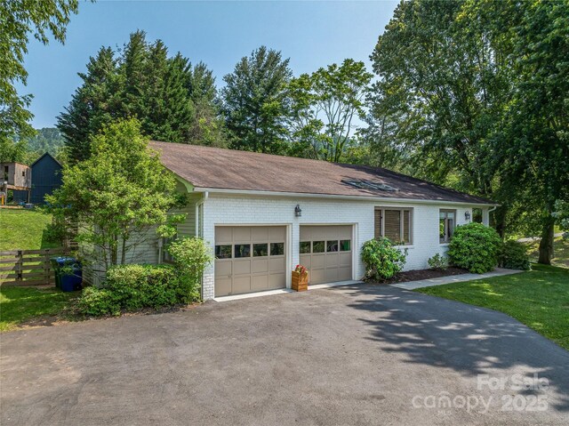 5 Lowry Ln, Weaverville, NC 28787 - view of front of home featuring an attached garage, driveway, and brick siding