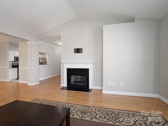 5617 Fairview Rd Unit 9, Charlotte, NC 28209 - unfurnished living room with light wood-style flooring, lofted ceiling, and a fireplace with flush hearth