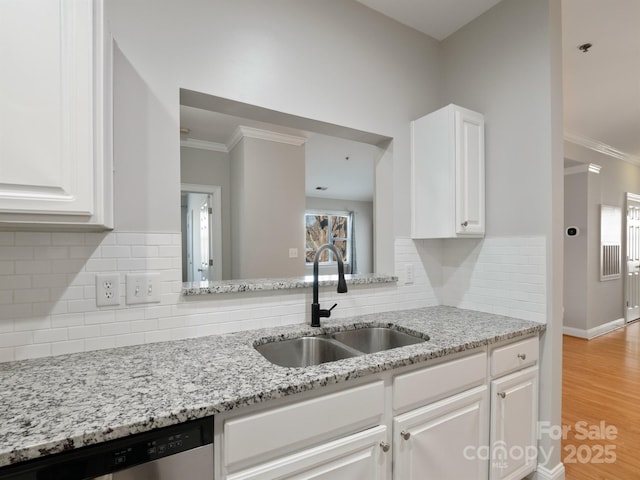 5617 Fairview Rd Unit 9, Charlotte, NC 28209 - kitchen featuring dishwasher, white cabinets, ornamental molding, light wood finished floors, and light stone counters