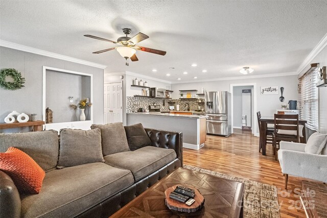 1197 Fincher Rd, Fort Lawn, SC 29714 - living room featuring ceiling fan, ornamental molding, a textured ceiling, recessed lighting, and light wood finished floors