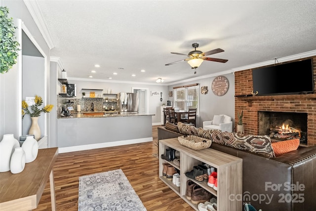 1197 Fincher Rd, Fort Lawn, SC 29714 - living room with crown molding, ceiling fan, a textured ceiling, wood finished floors, and a fireplace