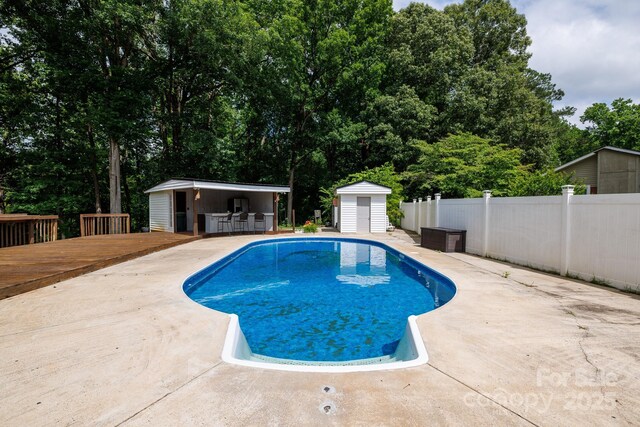 1197 Fincher Rd, Fort Lawn, SC 29714 - view of swimming pool with a wooden deck, a patio, and view of wooded area