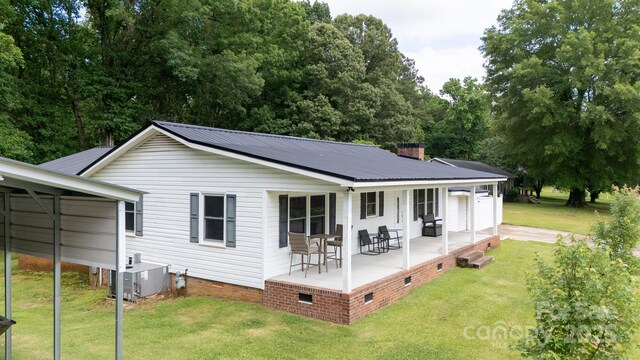 1197 Fincher Rd, Fort Lawn, SC 29714 - rear view of house with crawl space, a yard, cooling unit, metal roof, and a chimney