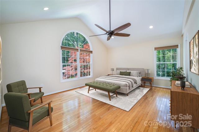 114 Coachmans Trl, Asheville, NC 28803 - bedroom featuring multiple windows, vaulted ceiling, light wood finished floors, and ceiling fan