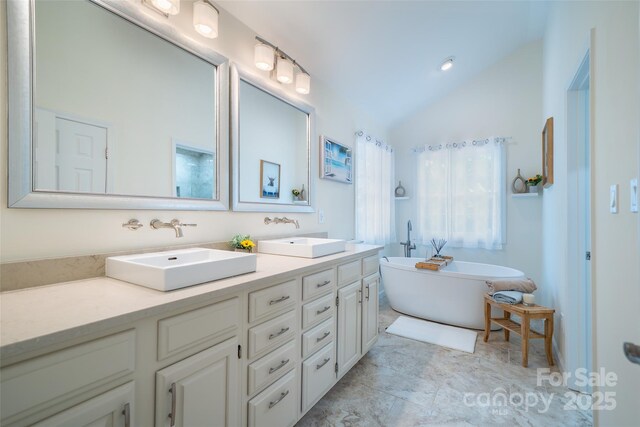 114 Coachmans Trl, Asheville, NC 28803 - bathroom featuring lofted ceiling, double vanity, and a freestanding bath