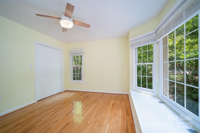 114 Coachmans Trl, Asheville, NC 28803 - unfurnished bedroom with light wood finished floors, a ceiling fan, and a closet