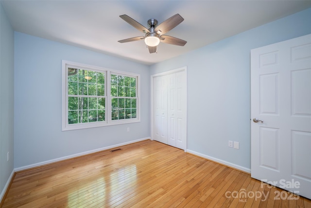 114 Coachmans Trl, Asheville, NC 28803 - unfurnished bedroom with light wood finished floors, a closet, and a ceiling fan