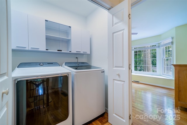 114 Coachmans Trl, Asheville, NC 28803 - laundry room featuring cabinet space, washer and dryer, and light wood-style flooring