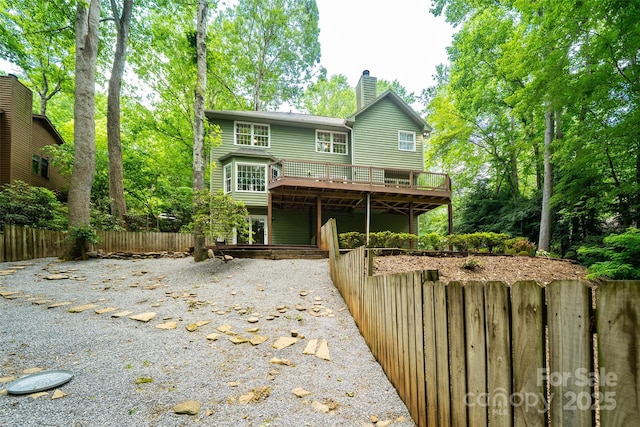 114 Coachmans Trl, Asheville, NC 28803 - back of house featuring a wooden deck and a chimney