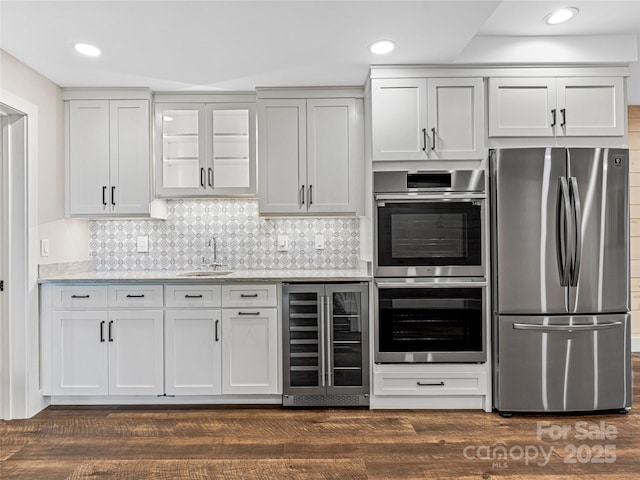 251 Toxaway Ct, Lake Toxaway, NC 28747 - kitchen with appliances with stainless steel finishes, wine cooler, a sink, decorative backsplash, and recessed lighting