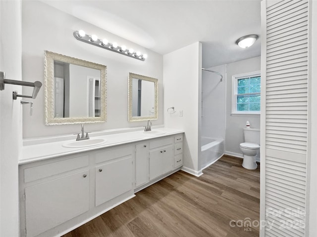 1224 Bethlehem Rd, Kings Mountain, NC 28086 - bathroom with double vanity, bathing tub / shower combination, wood finished floors, toilet, and baseboards