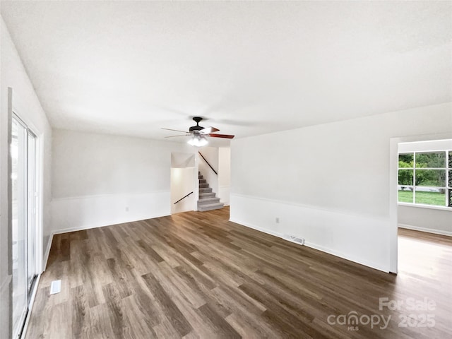 1224 Bethlehem Rd, Kings Mountain, NC 28086 - unfurnished living room featuring wood finished floors, a ceiling fan, stairs, and baseboards