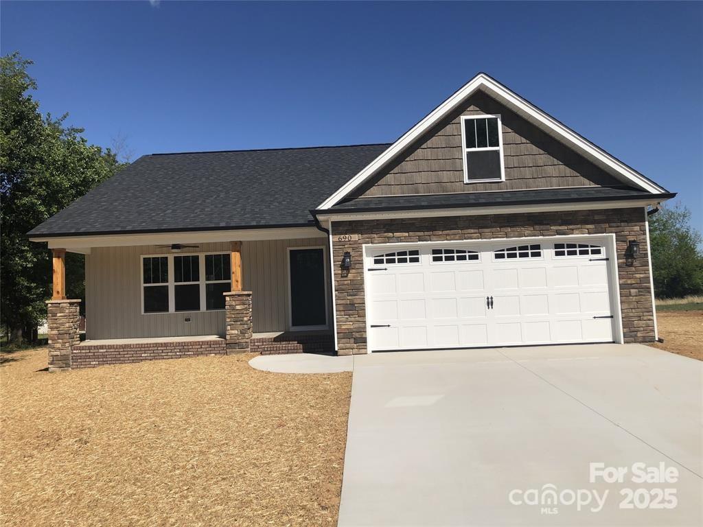 650 Fisher Dr Unit 3, Rockwell, NC 28138 - craftsman inspired home with driveway, a garage, a porch, stone siding, and a shingled roof