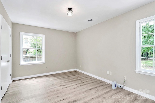 7118 April Ridge Ln, Charlotte, NC 28215 - spare room featuring healthy amount of natural light, light wood-style flooring, and baseboards