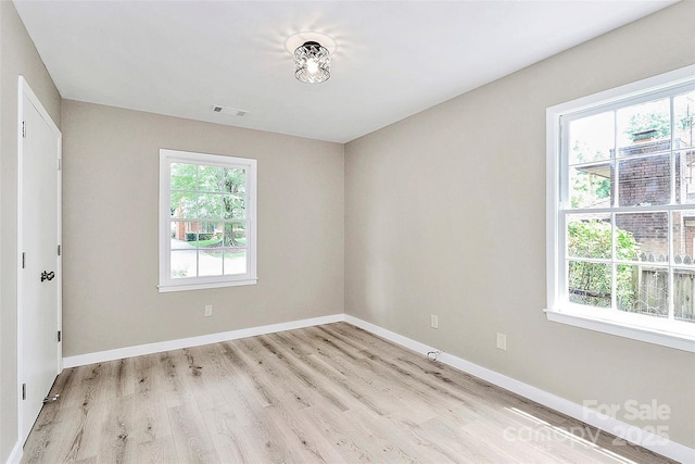 7118 April Ridge Ln, Charlotte, NC 28215 - spare room with plenty of natural light, light wood-type flooring, and baseboards