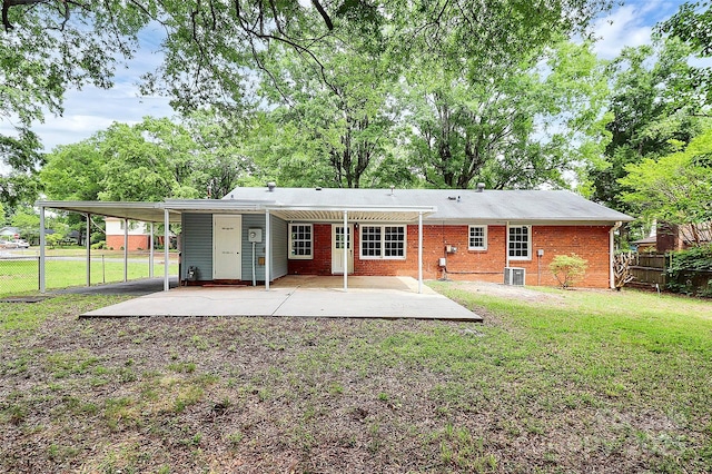 7118 April Ridge Ln, Charlotte, NC 28215 - back of house with central air condition unit, a carport, and brick siding