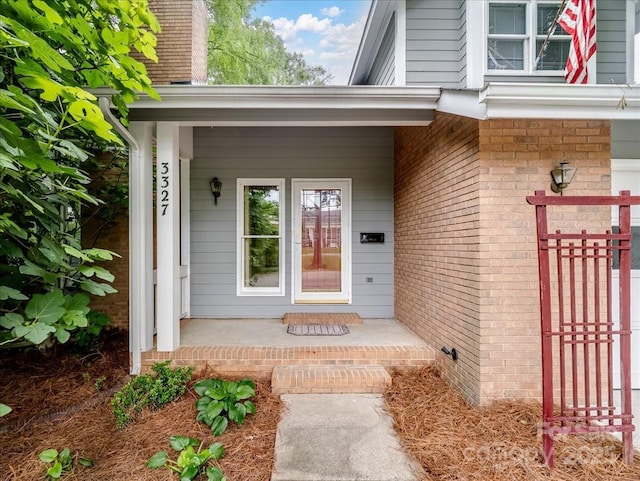 3327 Archdale Dr, Charlotte, NC 28210 - view of exterior entry featuring a porch and brick siding