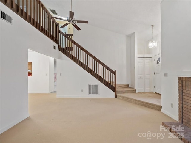3327 Archdale Dr, Charlotte, NC 28210 - unfurnished living room with a high ceiling, carpet, stairway, baseboards, and a ceiling fan