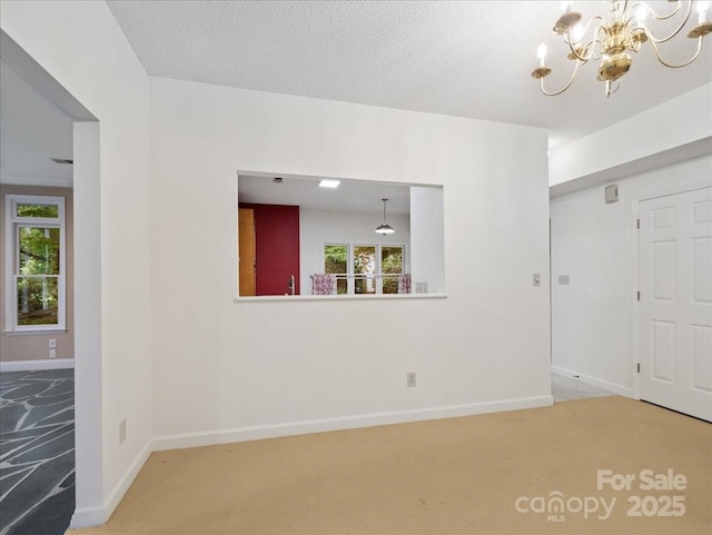 3327 Archdale Dr, Charlotte, NC 28210 - carpeted spare room featuring a chandelier, plenty of natural light, and baseboards