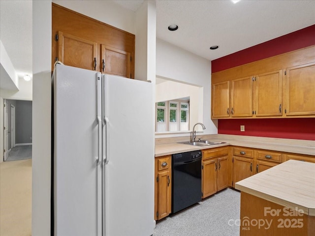 3327 Archdale Dr, Charlotte, NC 28210 - kitchen with dishwasher, freestanding refrigerator, a sink, light countertops, and brown cabinets