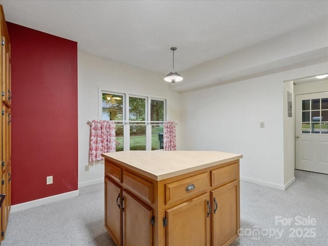 3327 Archdale Dr, Charlotte, NC 28210 - kitchen with light colored carpet, baseboards, hanging light fixtures, and a kitchen island