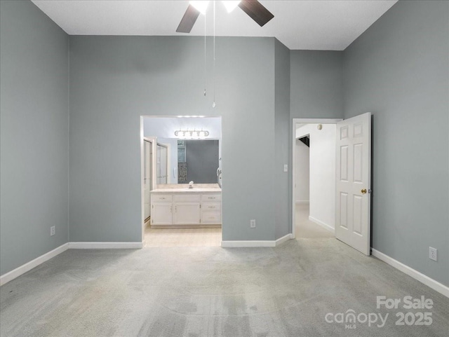 3327 Archdale Dr, Charlotte, NC 28210 - unfurnished bedroom featuring light carpet, baseboards, connected bathroom, a high ceiling, and ceiling fan